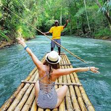 Bamboo raft captain guiding guests on Martha Brae River